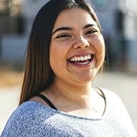A young woman smiling after finding out 